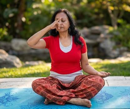 Beginner practicing breathwork and pranayama techniques outdoors for mental clarity and relaxation - Ambashri Yoga