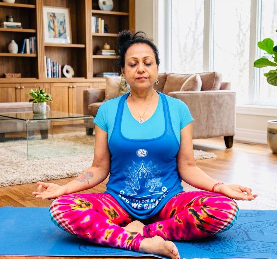 Sushma Srivastava practicing mindful yoga and meditation, welcoming visitors to holistic wellness programs in San Francisco Bay Area - Ambashri Yoga
