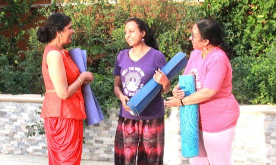 Sushma Srivastava providing individual attention and custom yoga instruction during a private Bay Area class